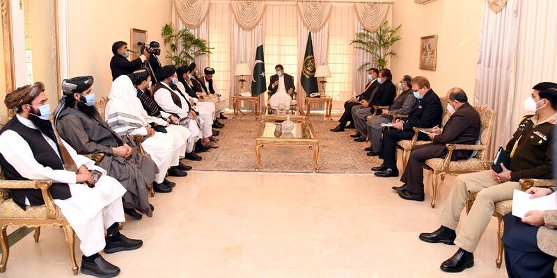 A Taliban delegation talking to Pakistan's Prime Minister Imran Khan in Islamabad last week. The two groups met to discuss an ongoing peace process. EPA