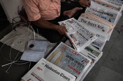 A newspaper seller in New Delhi sorts the June 5 morning editions after India's general election results were announced. Getty Images