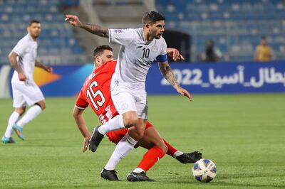 Al Shabab midfielder Ever Banega is challenged by Al Jazira's defender Mohammed Rabii during a AFC Champions League group B match on April 11, 2022. Fayez Nureldine / AFP
