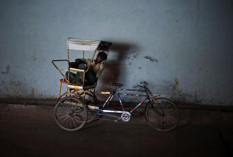 A man takes a nap on his cycle rickshaw under a bridge on a hot summer day in the old quarters of Delhi. Adnan Abidi/ Reuters