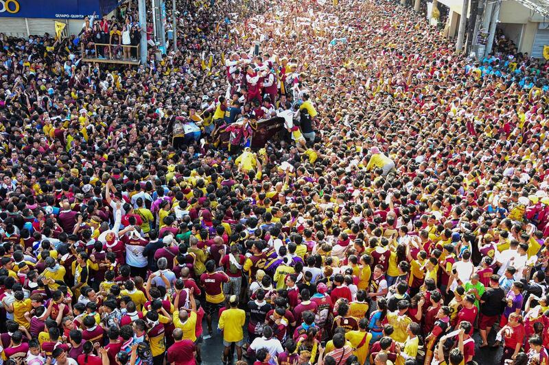 Devotees follow the carriage transporting the statue of the Black Nazarene. AFP