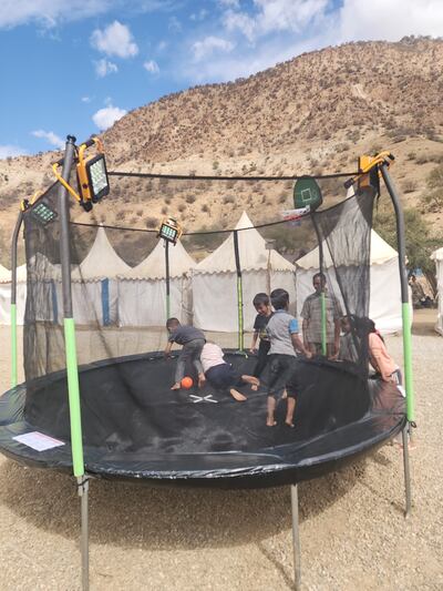 Children play on a trampoline at the camp.