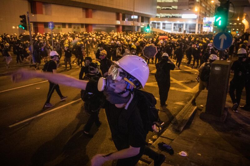 HONG KONG, HONG KONG - JULY 21: Protesters clash with police after taking part in an anti-extradition bill march on July 21, 2019 in Hong Kong, China. Pro-democracy protesters have continued weekly rallies on the streets of Hong Kong against a controversial extradition bill since  June 9, as the city plunged into crisis after waves of demonstrations and several violent clashes. Hong Kong's Chief Executive Carrie Lam apologized for introducing the bill and recently declared it "dead", however protesters have continued to draw large crowds with demands for Lam's resignation and completely withdraw the bill. (Photo by Chris McGrath/Getty Images)