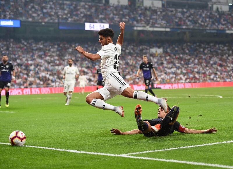 Real Madrid forward Marco Asensio is fouled in the penalty area by Leganes defender Unai Bustinza. Getty Images