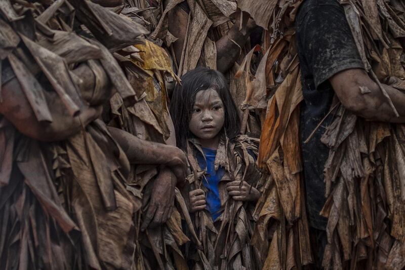 Devotees covered in mud and dried banana leaves take part in the Taong Putik ("mud people") Festival in the village of Bibiclat in Aliaga town, Nueva Ecija province, Philippines. Getty