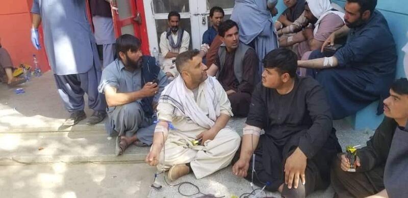A photo provided by residents of Kandahar shows Afghans donating blood after an attack on the Imam Bargah mosque.