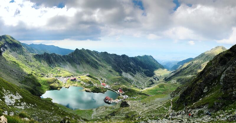 A lake reflects the sky beside the Transfagarasan Highway in Romania. Unsplash