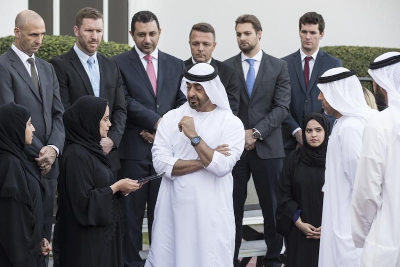 Sheikh Mohammed bin Zayed speaks with Dr Mouza Al Shehhi and staff from the National Service Authority. With them is Sheikh Ahmed bin Tahnoon, Chairman of the National Service Authority. Ryan Carter / Crown Prince Court - Abu Dhabi