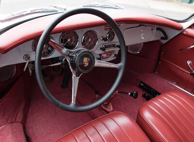 The Porsche's interior retains its old-school feel, with red carpeting, scarlet leather upholstery and period instrumentation.