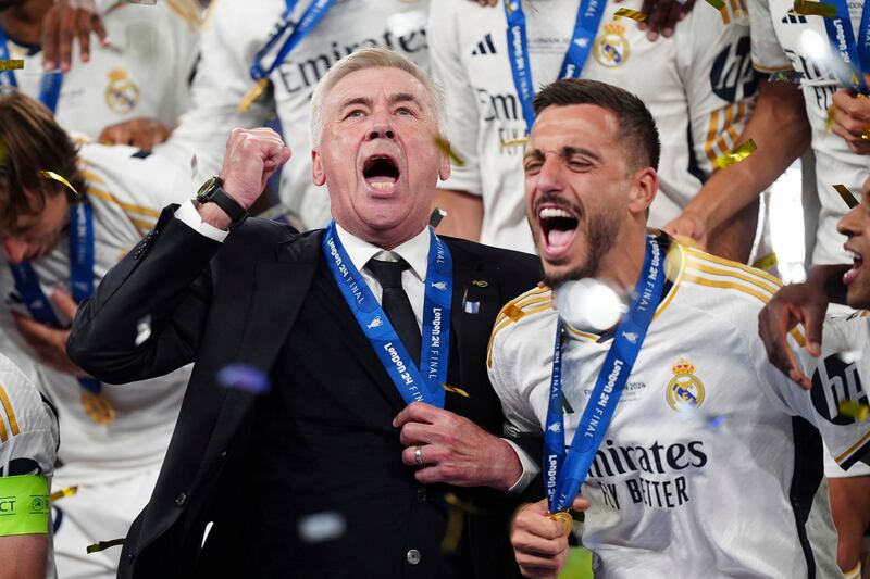 Real Madrid manager Carlo Ancelotti celebrates with his team after winning the Champions League. PA