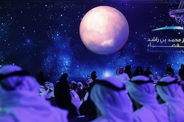 United Arab Emirates (UAE) officials, engineers and scientists take part in a ceremony to unveil UAE's Mars Mission on May 6, 2015 in Dubai. The UAE Mars Mission aims to provide a global picture of the Martian atmosphere through a probe named Al Amal to be launched in July 2020 to reach Mars in 2021, according to the engineers involved in the project. AFP PHOTO / KARIM SAHIB (Photo by KARIM SAHIB / AFP)