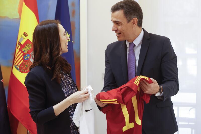 Mr Sanchez and his New Zealand counterpart Jacinda Ardern hold the jerseys of their national football teams during a meeting at Moncloa Palace. EPA