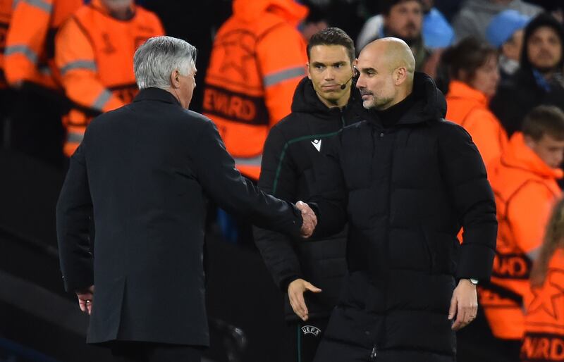 Carlo Ancelotti and  Pep Guardiola shake hands after the match. EPA