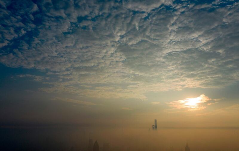 The sun rises over the financial district of Pudong on a polluted day in Shanghai, China. Johannes Eisele/AFP