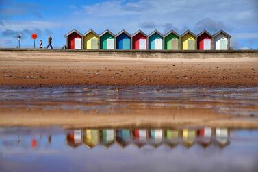 People walk along the sea front, in Blyth, Northumberland, England, Monday May 24, 2021. (Owen Humphreys/PAvia AP)