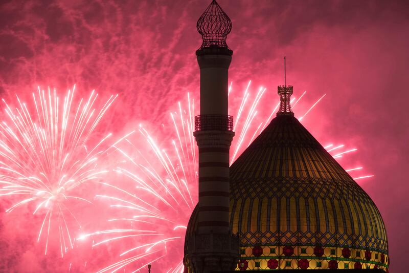 The former cigarette factory Yenidze, built 1909 in the style of a mosque, is illuminated by a firework that brightens the night sky in Dresden, Germany. Sebastian Kahnert / dpa via AP