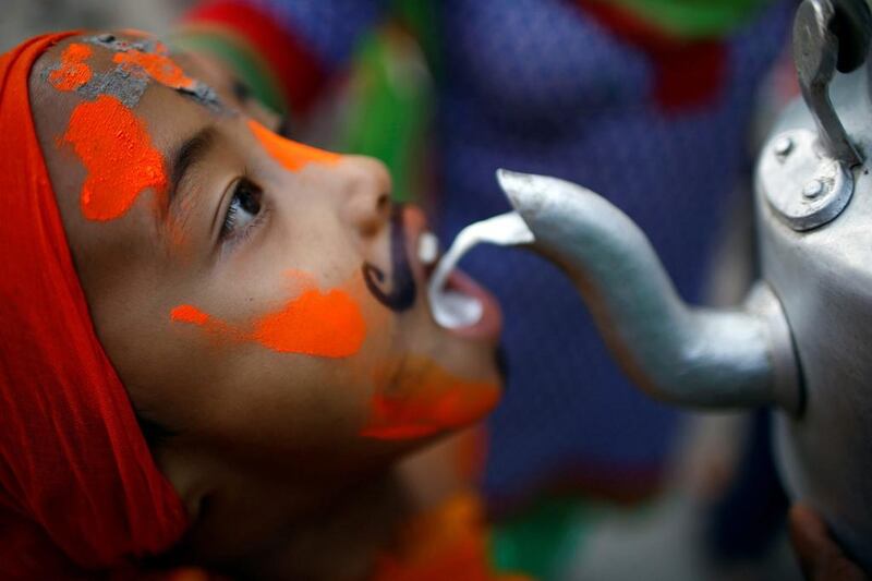 A boy is offered milk as he participates in a parade to mark the Gaijatra festival in Kathmandu. Navesh Chitrakar / Reuters