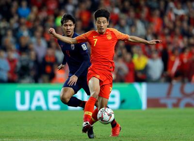 China's defender Wu Lei, right, duels for the ball with Thailand's defender Chalermpong Kerdka during the AFC Asian Cup round of 16 soccer match between Thailand and China at the Hazza Bin Zayed stadium in Al Ain, United Arab Emirates, Sunday, Jan. 20, 2019. (AP Photo/Hassan Ammar)