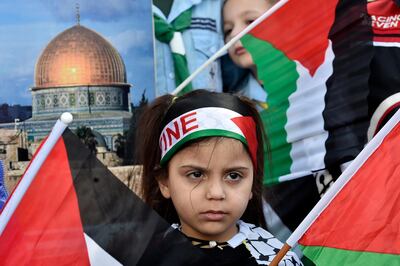 epa08181842 A Palestinian girl with a national flag on her head attends a protest against the so-called 'Deal of the Century', planned by US President Trump to solve the conflict between Palestinians and Israel, in Bourj al-Barajneh Palestinian refugee camp, in the southern suburb of Beirut, Lebanon, 31 January 2020. US President Trump and Israeli Prime Minister Benjamin Netanyahu announced at a press conference at the White House on 28 January, the US peace plan for the Palestinian-Israel conflict.  EPA/WAEL HAMZEH
