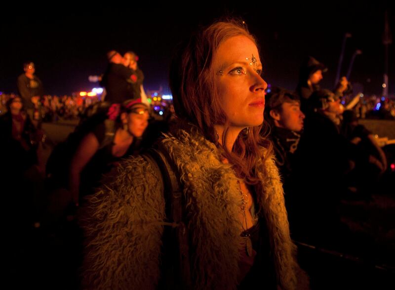 Krissy Humphreys watches The Man being burned during the Burning Man 2011 "Rites of Passage" arts and music festival in the Black Rock desert of Nevada, September 3, 2011. More than 50,000 people from all over the world have gathered at the sold out festival which is celebrating its 25th year.    REUTERS/Jim Urquhart  (UNITED STATES - Tags: SOCIETY) FOR EDITORIAL USE ONLY. NOT FOR SALE FOR MARKETING OR ADVERTISING CAMPAIGNS. NO THIRD PARTY SALES. NOT FOR USE BY REUTERS THIRD PARTY DISTRIBUTORS *** Local Caption ***  SLC31_BURNING MAN U_0904_11.JPG