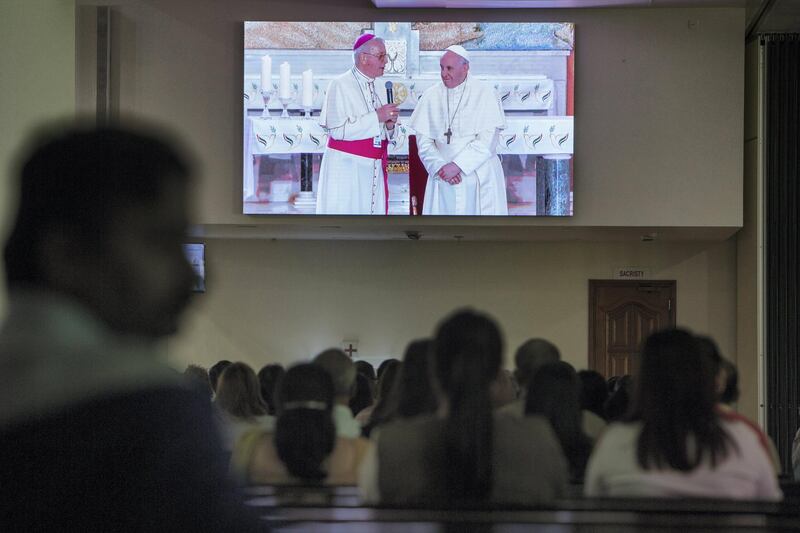  DUBAI, UNITED ARAB EMIRATES - Worshipper watch Pope Francis arrived at St. Francis Church in Abu Dhabi at St. Mary's Church, Oud Mehta.  Leslie Pableo for The National for Nick Webster's story