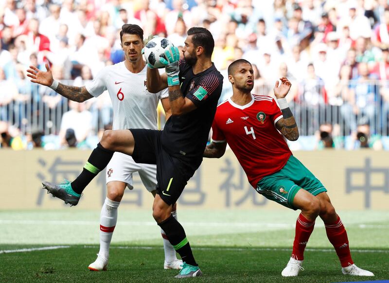 Portugal's Rui Patricio and Jose Fonte in action with Morocco's Manuel da Costa. Kai Pfaffenbach / Reuters