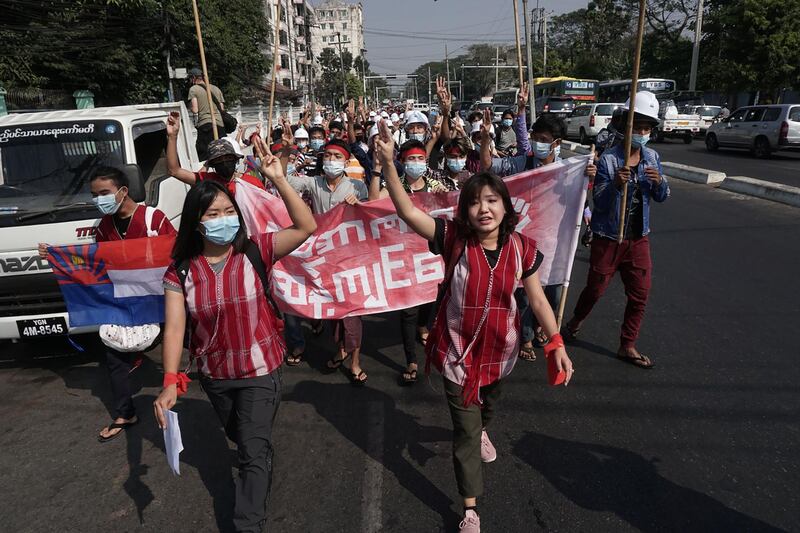 Protesters give the three-finger salute during a demonstration against the military coup in Yangon.  AFP