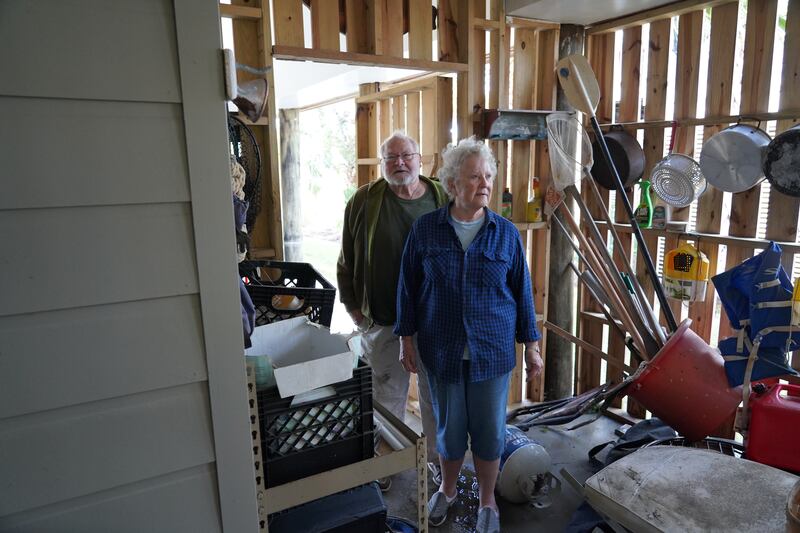 Sumter and Beverly Moore look through their cluttered belongings drenched by Hurricane Ian. Joshua Longmore / The National