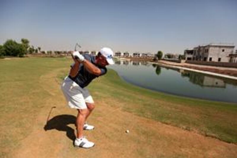 The Jumeirah Golf Estates teaching professional, Wayne Johnson, tees up on the challenging 17th hole at the Greg Norman-designed Earth Course.