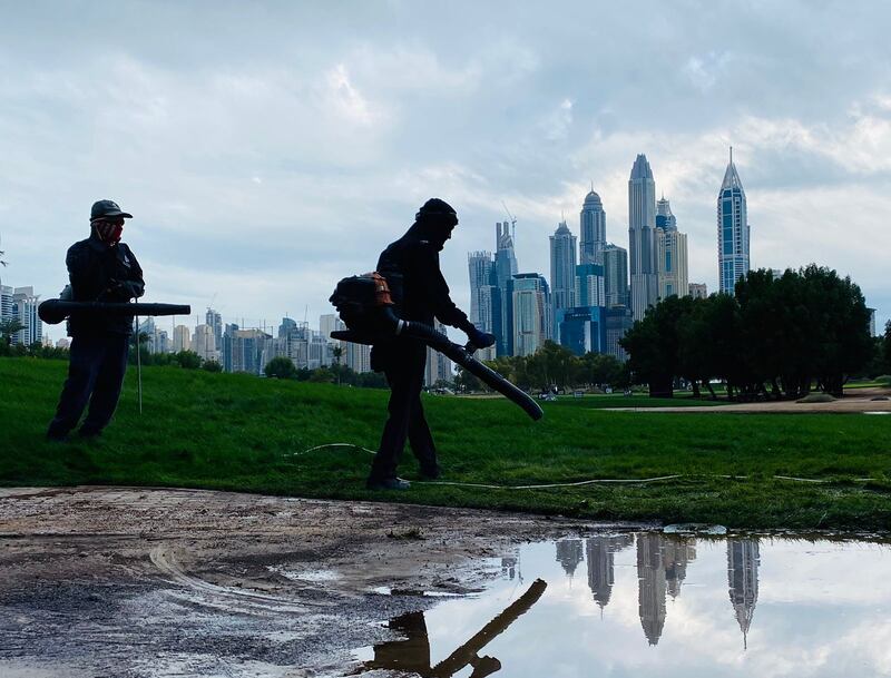 Staff at Emirates Golf Club ready the course for Day 2 of the Hero Dubai Desert Classic after more overnight rain. All photos: Paul Radley / The National