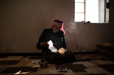 Ibrahim Al Shawakh looks at documents in his home on the outskirts of Raqqa. Tom Nicholson for The National