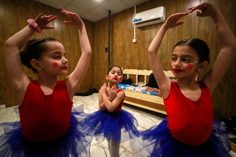 Dancers from the academy get ready backstage before their performance.  AFP