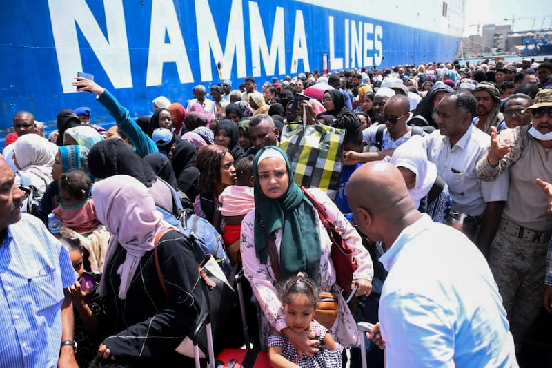 People fleeing war-torn Sudan queue to board a boat from Port Sudan. AFP