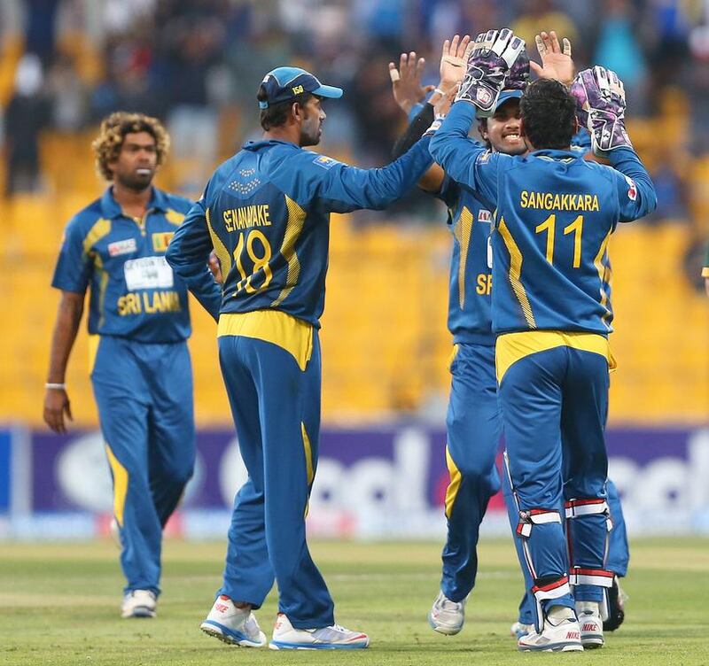 Sri Lankan players celebrate the dismissal of Pakistani batsman Misbah ul Haq during the fifth one-day international match yesterday in Abu Dhabi. Marwan Naamani / AFP