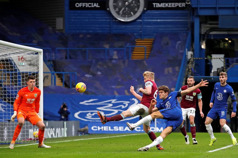 Chelsea's Spanish defender Marcos Alonso (3R) scores his team's second goal past Burnley's English goalkeeper Nick Pope during the English Premier League football match between Chelsea and Burnley at Stamford Bridge in London on January 31, 2021. (Photo by ANDREW COULDRIDGE / POOL / AFP) / RESTRICTED TO EDITORIAL USE. No use with unauthorized audio, video, data, fixture lists, club/league logos or 'live' services. Online in-match use limited to 120 images. An additional 40 images may be used in extra time. No video emulation. Social media in-match use limited to 120 images. An additional 40 images may be used in extra time. No use in betting publications, games or single club/league/player publications. / 