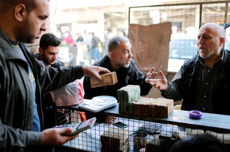 Money changers and customers at a foreign currency exchange market in Baghdad. Reuters