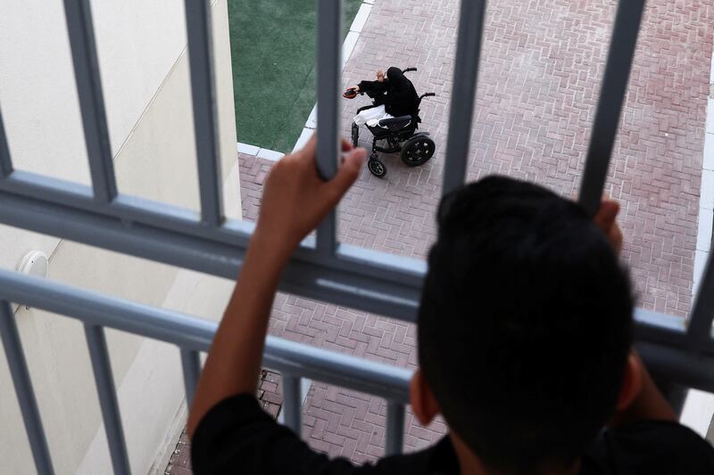 A Palestinian child watches his friend Tuqa Ibrahim, 12, before iftar in Emirates Humanitarian City. Tuqa lost her legs during an Israeli air strike in Gaza. Reuters