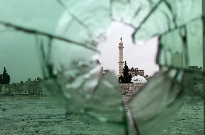 A mosque is pictured through shattered glass in the old city of Homs, rebel fighters withdrew from the city centre in line with a negotiated withdrawal deal with the government after having held out under tight siege for nearly two years. Youssef Karwashan / AFP Photo