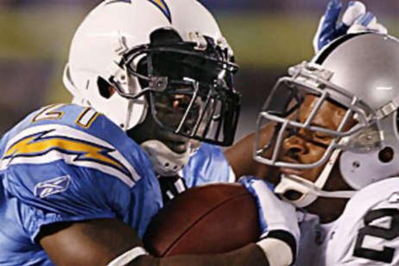 LaDainian Tomlinson, left, gets physical with the Oakland Raiders' Nnamdi Asomugha during the San Diego Chargers much needed win to keep their play-off hopes alive.