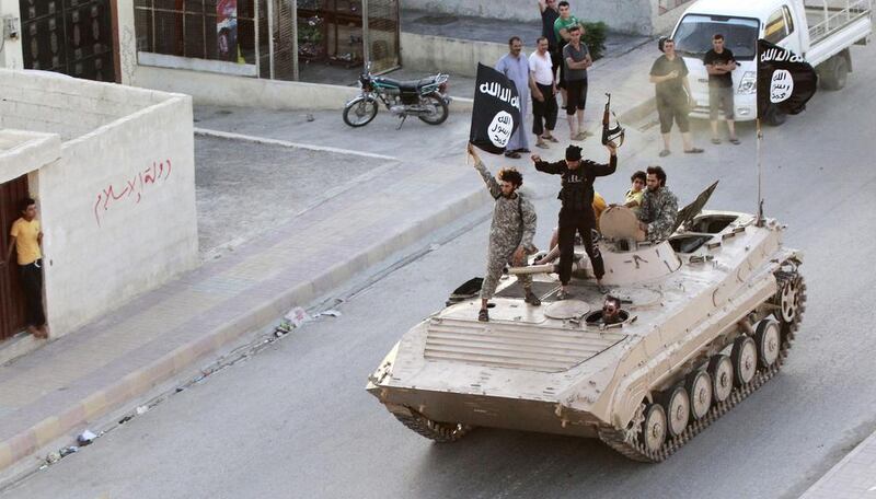 Militant Islamist fighters take part in a military parade along the streets of northern Raqqa province. REUTERS/Stringer 

