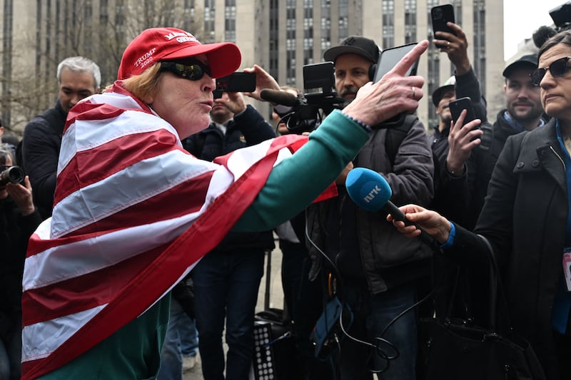 A Trump supporter yells at members of the press outside the Manhattan District Attorney's office. AFP