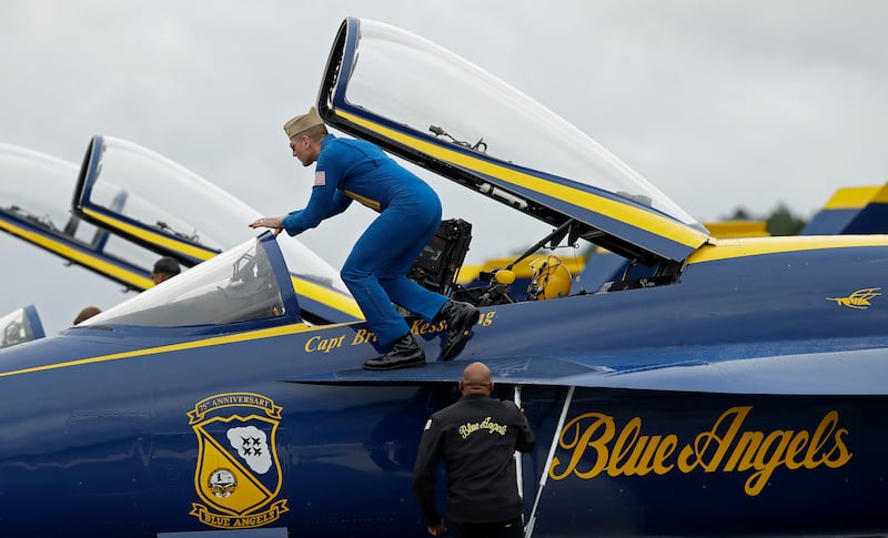 US Navy Captain Brian Kesserling, Blue Angel flight leader, climbs into an F/A-18E Super Hornet jet in Rome, Georgia. AP
