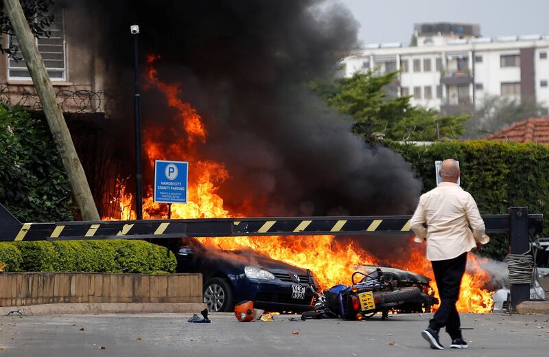Cars are seen on fire at the scene. Thomas Mukoya / Reuters