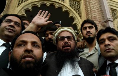 epaselect epa06344914 Hafiz Saeed (C), the head of banned Islamic charity Jamat ud Dawa, waves to supporters after he was released by a court in Lahore, Pakistan, 22 November 2017 (issued 23 November 2017). A review board of the Lahore High Court on 22 November ordered the release of Hafiz Saeed from house arrest as the government failed to file charges against him since January 2017. Hafiz Saeed was on house arrest since January 2017 after Jamaat-ud-Dawa was declared as a banned outfit in resolution of the Security Council of the United Nations (UN) where Saeed was alleged to be the mastermind of coordinated attacks on the Indian city of Mumbai in 2008 that killed more than 160 people.  EPA/RAHAT DAR