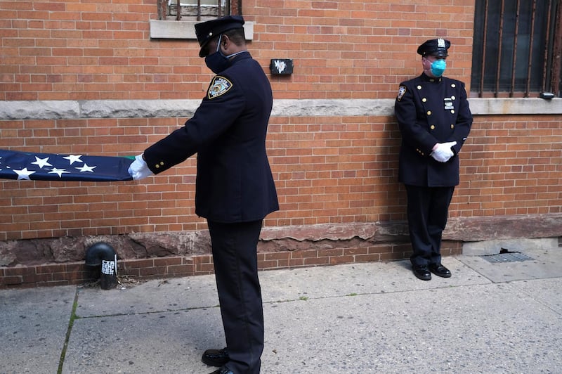 Members of the NYPD Honor Guard, wearing masks, prepare for the funeral of Traffic Section Commander Mohammed Chowdhury in New York, on April 22, 2020. AP Photo