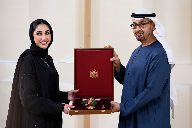 President Sheikh Mohamed presents a Zayed the Second Medal to Fatima Al Bishr