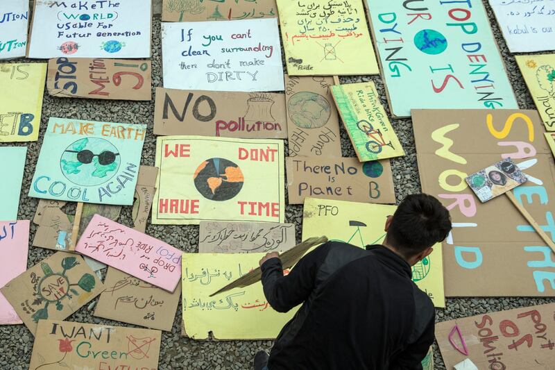 Activists drew posters with climate change messages to be used during protests in the city. 