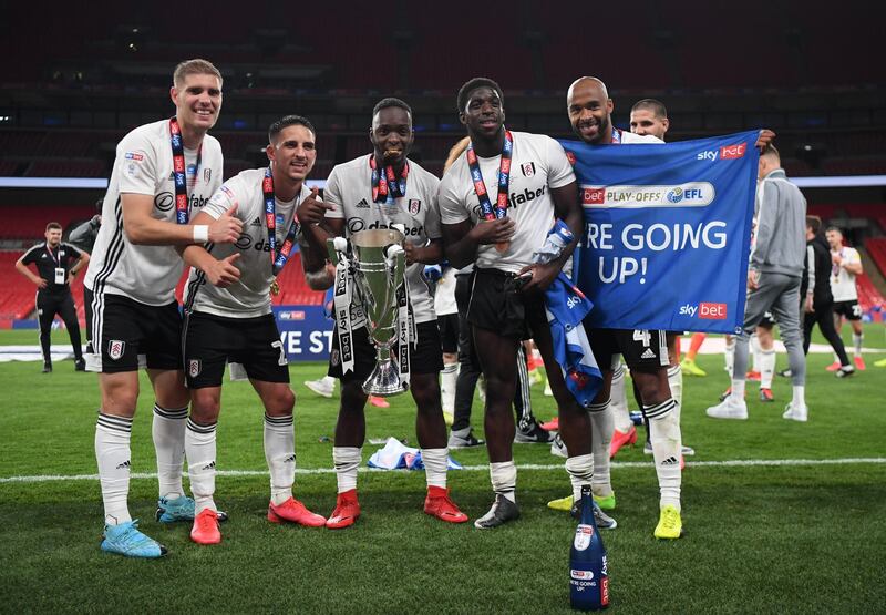 Fulham players celebrate with the trophy. Getty