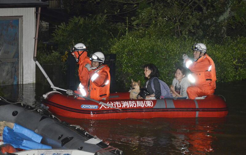 Local residents are evacuated by boat from an inundated house due to a heavy rain triggered by Typhoon Talim, in Oita, southern Japan, in this photo taken by Kyodo September 17, 2017. Mandatory credit Kyodo/via REUTERS ATTENTION EDITORS - THIS IMAGE WAS PROVIDED BY A THIRD PARTY. MANDATORY CREDIT. JAPAN OUT. NO COMMERCIAL OR EDITORIAL SALES IN JAPAN.