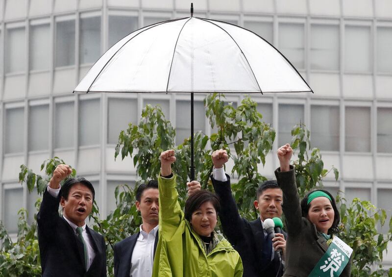 Head of Japan's Party of Hope and Tokyo Governor Yuriko Koike, centre, and her party lawmakers raise their fists during the last day of campaigning for the October 22 lower house election, in Tokyo, Japan. Issei Kato / Reuters